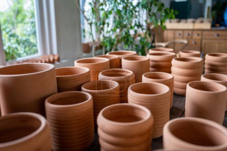 Photo for Terracotta pots in different sizes in plant shop. Traditional handmade clay pots and earthenware jar on market or bazaar. Earthen pottery at plants store. Gardening concept - Royalty Free Image