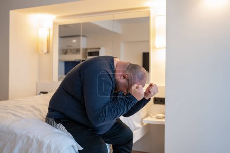 Photo for Frustrated apathy heavy man cover face sit on bed at home alone with health trouble. Upset sad overweight male suffering from break up, divorce, have bad relationship, feel lonely, depressed, hopeless - Royalty Free Image