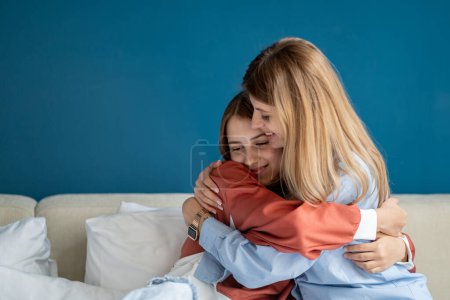 Caring European mother hugging teenage girl. Pleased mom and teen daughter feel grateful thankful, show love and care, enjoy tender. Family embracing, having intimate moment together as best friends. 