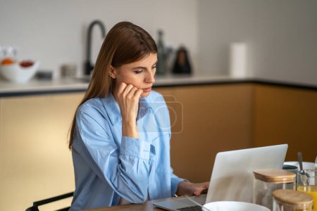 Photo for Workaholic. Focused business woman freelancer working on laptop, very early work, sitting and have job breakfast. No rest break when project deadline. Single mom overtime busy - Royalty Free Image
