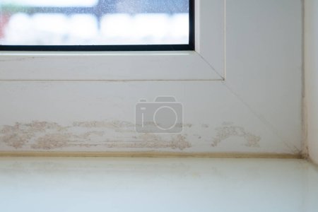 Photo for Dirty window frame after sealing cracks with duct tape. Need special cleaners for difficult stains. Cleaning call after renovation work. Damaged frames with glue residue plaque on surface. Dusty glass - Royalty Free Image