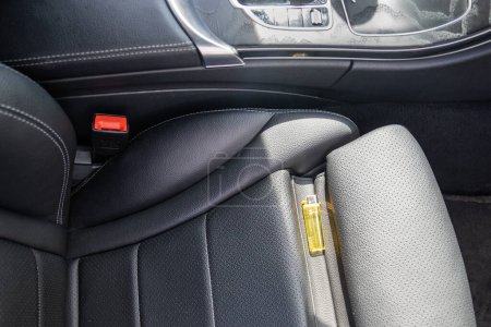 Photo for Forgotten gas lighter in car on seat can lead to fire in sunny hot weather. Rays of sun heating lighter on drivers seat. Random dangerous life situations. Carelessness in use of flammable objects. - Royalty Free Image
