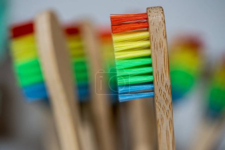 Photo for Closeup of eco friendly bamboo toothbrushes with recycled plastic bristles of different colors. Biodegradable ecological personal care products. Plastic free lifestyle, environmental protection. - Royalty Free Image