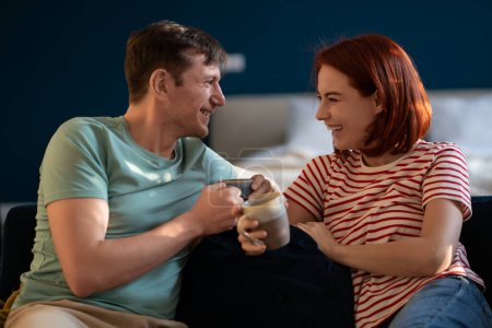 Photo for Husband and wife communicate, drink coffee. Romantic couple happily laughing, smiling, having fun, enjoying each other company, getting closer. Cheerful joyful conversations, friendly chat talk - Royalty Free Image