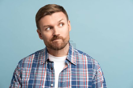 Photo for Thoughtful middle aged male pursing lips look in upper right corner, on copy space. Suspicious person. Funny skeptical pensive man makes doubtful choice, solving problem, isolated studio background. - Royalty Free Image