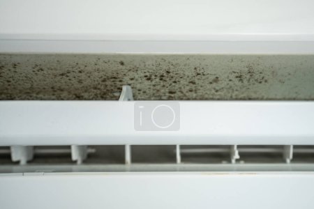 Photo for Mold in air conditioner, untimely cleaning late maintenance in humid climate. Dirt, dust, pathogenic viruses and microbes inside air conditioner. Health hazards, risks of dangerous mould concept. - Royalty Free Image