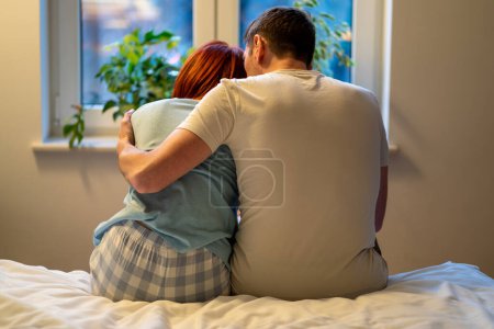 Photo for Backs of hugging man and woman. Guy and girl cuddle, husband comforts wife in difficult period of life, calms down after tantrum, crying, major quarrel and scandal. Loving relationship full of support - Royalty Free Image