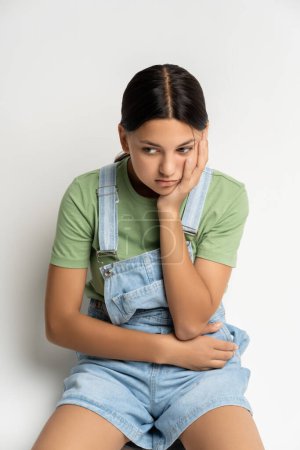 Photo for Depressed frustrated teen girl upset with bad test results, broken relations, family conflict, parents divorce, bullying, discrimination at school. Unhappy desperate girl thinks over problem solution - Royalty Free Image
