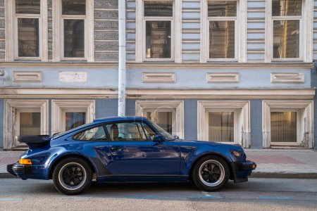 Photo for St. Petersburg Russia - July 10 2020. Old retro classic blue Porsche 911 Carrera car parking on the street. Historic sports car. - Royalty Free Image