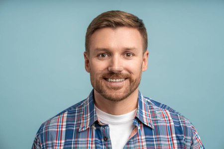 Photo for Portrait caucasian bearded man looking at camera smiling on blue background. Positive friendly blond white male feeling joy, optimism. Joyful relaxed guy enjoying life. Sincere human emotions concept. - Royalty Free Image