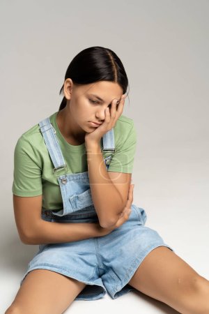 Photo for Depressed teen girl upset with harassment, pressure, offense, bullying from classmates at school, conflicts in family, broken relations with boyfriend. Desperate girl thinks over problem solution - Royalty Free Image