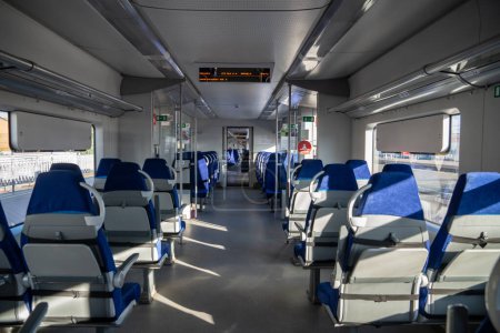 Téléchargez les photos : Interior of modern passenger high-speed express train, row of empty blue fabric soft seats selective soft focus. Inside the train carriage with comfortable and colorful chairs. Public transportation - en image libre de droit