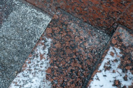 Photo for Deicing chemicals on steps in winter. Salt grains on icy stairs in cold season. Slippery surface sprinkled with technical salt and calcium. Prevent slipping concept - Royalty Free Image