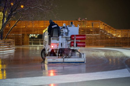 Photo for Ice preparation at rink. Ice rink resurfacer vehicle resurface machine outdoor between session. Maintenance. - Royalty Free Image