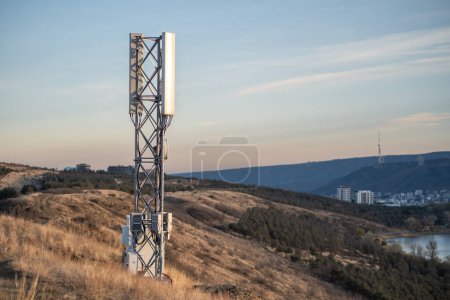 Photo for 5G mobile phone cellular tower. Next generation digital signal receiver used for ultrafast speed internet connection, telecommunication, data transmission. High metal steel structure standing on hill - Royalty Free Image