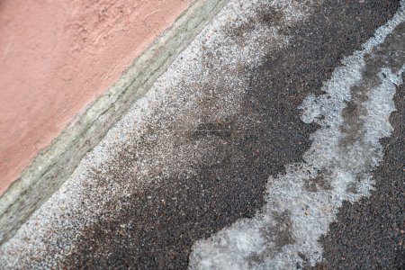 Photo for Deicing chemicals on pavement in winter. Salt grains on icy sidewalk, paving slab with rock salt in cold season. Slippery road sprinkled with technical salt and calcium. Prevent slipping concept - Royalty Free Image