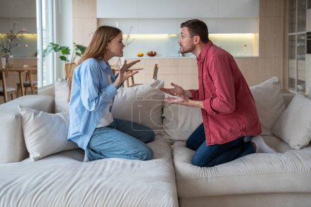 Angry emotional couple shouting, screaming, blaming each other. Scandal between annoyed irritated wife and defensive husband. Marital discord, toxic relations, conflicts, gaslighting in family life