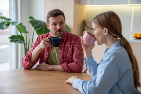 Photo for Married passionate couple plan future together sharing dreams, aspirations drinking coffee at home. Family bond between enthusiastic man and woman connection engaging conversation about goals together - Royalty Free Image