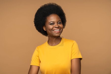 Photo for Cheerful glad overjoyed dark skinned african woman, smiling with cheeks dimples and unusual white teeth. Optimistic female with expression of joy and happiness on face, isolated on studio background - Royalty Free Image