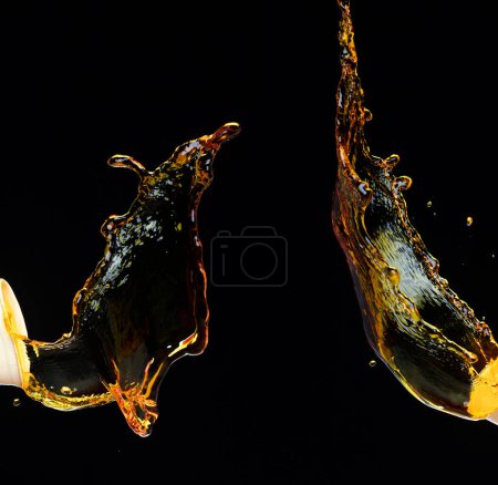 Photo for Orange, lemon juice or oil lubricant splash, liquid gold yellow drink drops. Fruit beverage water elements in line form . Fresh splashing and flowing jets, black background isolated freeze motion - Royalty Free Image