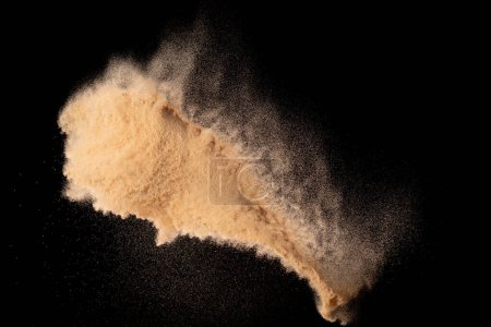 Photo for Small size fine Sand flying explosion, Golden grain wave explode. Abstract cloud fly. Yellow colored sand splash silica in Air. Black background Isolated high speed shutter, throwing freeze shot - Royalty Free Image
