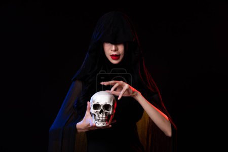 Photo for Old Witch costume woman craft spell horror magic on Horror night with Evil makeup face Art scary Magician smoke skull death hands. Creepy mystery lady over black background copy space - Royalty Free Image