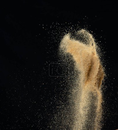 Téléchargez les photos : Explosion volante de sable, onde de sable doré exploser. Nuage de sable abstrait voler. Jaune éclaboussures de sable de couleur jetant dans l'air. Fond noir Obturateur isolé à grande vitesse, mouvement d'arrêt de gel de lancement - en image libre de droit