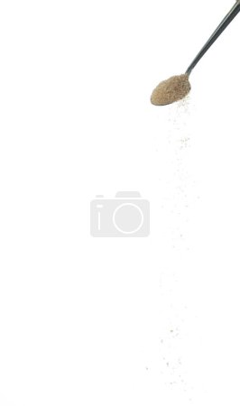 Photo for Brown Sugar fall, brown grain sugar pouring down abstract cloud fly from silver spoon. Beautiful complete seed sugarcane, food object design. Selective focus freeze shot white background isolated - Royalty Free Image