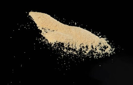 Photo for Brown Sugar flying explosion, brown grain sugar explode abstract cloud fly. Beautiful complete seed sugarcane splash in air, food object design. Selective focus freeze shot Black background isolated - Royalty Free Image
