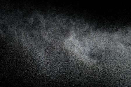 Foto de Million of Star Dust, Photo image of falling down shower rain snow, heavy snows storm flying. Freeze shot on black background isolated overlay. Spray water fog smoke as star particle on wind - Imagen libre de derechos