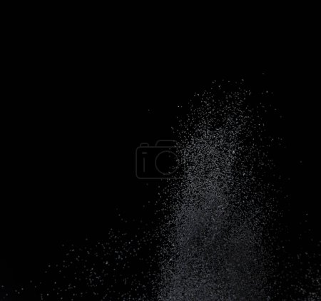 Foto de Million of black sand explosion, Photo image of falling down sands flying. Freeze shot on black background isolated overlay. Tiny Fine sand dust magnet as particle disintegrate science - Imagen libre de derechos