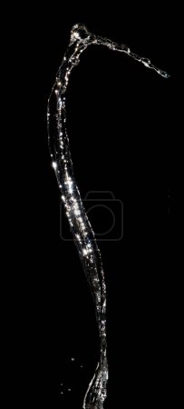 Photo for Shape form pouring of Water line fall to tube pine water in air and stop motion freeze shot. Pour Throw Water for shape line texture graphic resource elements, black background isolated - Royalty Free Image