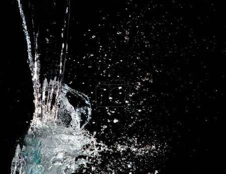 Photo for Water hit wall ground, explode into drop droplet. Amount Water attack impact and fluttering in air explosion. Stop motion freeze shot. Splash Water for texture elements, black background isolated - Royalty Free Image