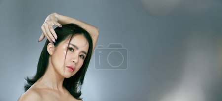 Foto de Half body face shot 20s 30s Asian Woman wear formal casual dress. Black straight hair female has beautiful make up feel happy smile fashion vintage poses over gray background isolated - Imagen libre de derechos