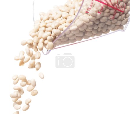 Foto de White bean fall down pour from measured cup, white bean float explode, abstract cloud fly. Off-white beans splash throwing in Air. White background Isolated high speed shutter, freeze motion - Imagen libre de derechos