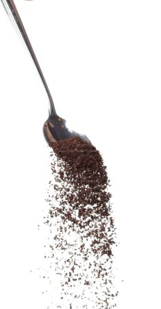 Foto de Coffee powder fall down pour in spoon, Coffee crushed float explode, abstract cloud fly. Coffee dust powder splash throwing in Air. White background Isolated high speed shutter, freeze motion - Imagen libre de derechos