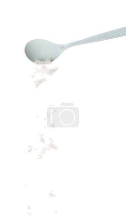 Photo for Crystal Salt fall down pouring in plastic spoon, flake white grain salts explode abstract cloud fly. Big size salt splash in air, food object element design. White background isolated high speed - Royalty Free Image