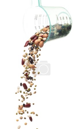 Photo for Mix beans fall down explosion, several kind bean float pouring in measured cup. Dried white green red soy black peanut mixed beans splash throwing in Air. White background Isolated high speed shutter - Royalty Free Image