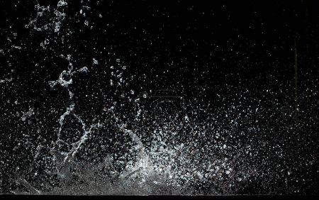 Foto de Blur Defocus Image of Water hit wall ground, explode into drop droplet. Amount Water attack impact and fluttering in air explosion. Stop motion freeze shot. Splash Water for texture elements - Imagen libre de derechos