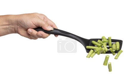 Foto de Chopped Long yard bean fly fall in turner, Cut green long beans for food cooking float in air. Raw slice long yard bean throw in mid air as food material. White background isolated high speed freeze - Imagen libre de derechos