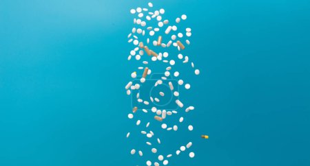 Photo for Daily pill drug medicine falling down float to patient. Many kind of drugs pills medicines to help patient fly to senior. Mixed combination Drug pill medicine Medical over blue background isolated - Royalty Free Image