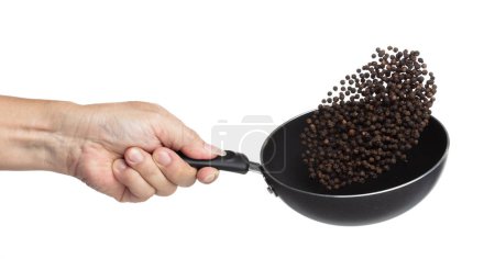 Photo for Black Pepper seeds fly throw up in pan, Black Pepper float explode, abstract cloud fly. Black Peppercorn splash throwing in Air. White background Isolated high speed shutter, freeze motion - Royalty Free Image