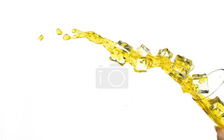 Foto de Pouring lime juice down to glass, lime juice fall down in yellow liquid water. Cold Ice Cube mix green lime juice throw splash in air. White background Isolated high speed shutter, freeze action - Imagen libre de derechos