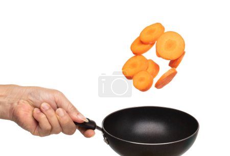 Foto de Carrot fresh fly float in Air turn to slice shape. Beta Carotene orange color in Carrot is good health. Many Dice cube carrot flying throw up in Air by cooking pan. White background isolated - Imagen libre de derechos