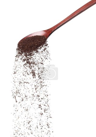 Coffee powder fall down pour in wooden spoon, Coffee crushed float explode, abstract cloud fly. Coffee dust powder splash throwing in Air. White background Isolated high speed shutter, freeze motion