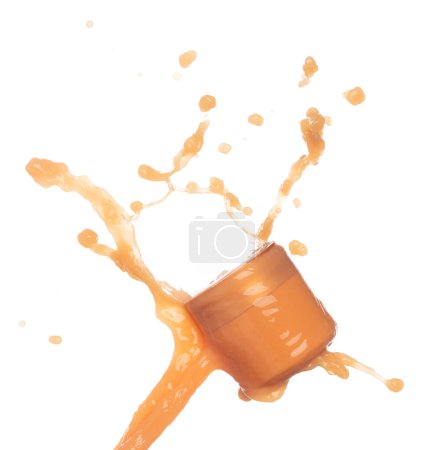 Photo for Orange Juice moisturizer lotion cream pouring down in cosmetic bottle container. Orange paint beauty lotion fluttering explosion in air, splash spill like explosion droplet. White background isolated - Royalty Free Image