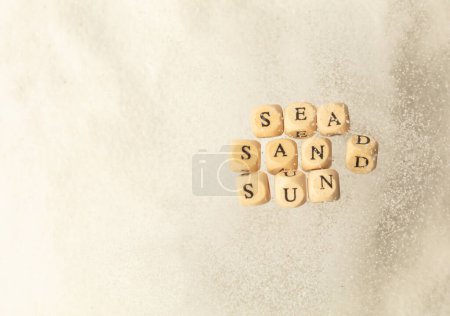 Photo for Alphabet letter wording "Sea Sand Sun" bead toy flying over explosion flying in air. Sea Sand Sun word alphabet letter show tropical island beach white sand for vacation holiday. Top view action - Royalty Free Image
