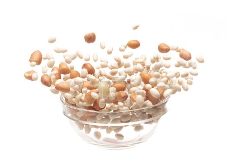 Foto de Mix white peanut beans fall down explosion, several kind bean float explode in glass bowl. Dried white peanut mixed beans splash throwing in Air. White background Isolated high speed shutter, freeze - Imagen libre de derechos