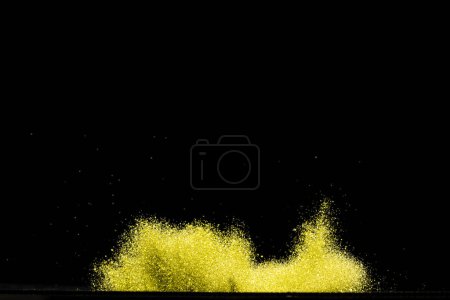 Photo for Explosion metallic gold glitter sparkle. Golden Glitter powder spark blink celebrate, blur foil explode in air, fly throw gold glitters particle. Black background isolated, selective focus Blur bokeh - Royalty Free Image