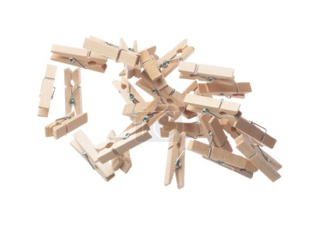 Photo for Wooden clothespins float gracefully in air, purposeful clips and holds transformed into a dance of household order and creative inspiration. Beige bundle of laundry dangles. White background isolated - Royalty Free Image